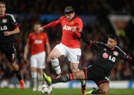 Rooney hits landmark in Leverkusen win