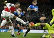 Inspired Ozil fires Arsenal to top spot